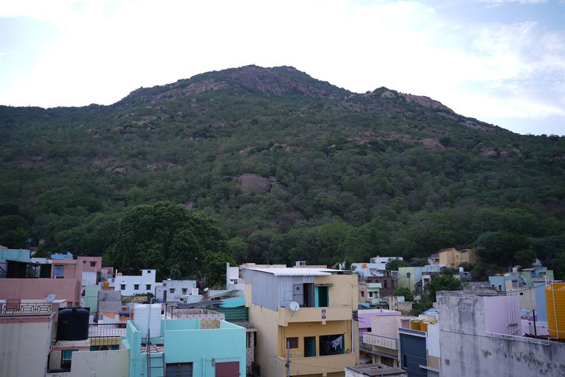 Arunachala hill with colourful city in the foreground, alternate angle