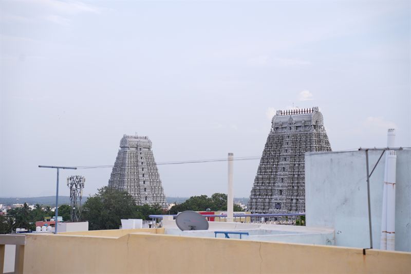 Two large temple gopurams seen close-up from the rooftop